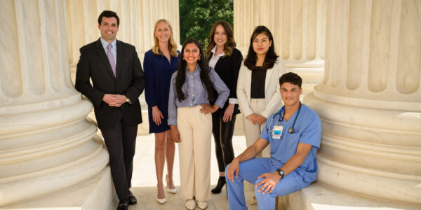 diverse group of professionals standing between columns