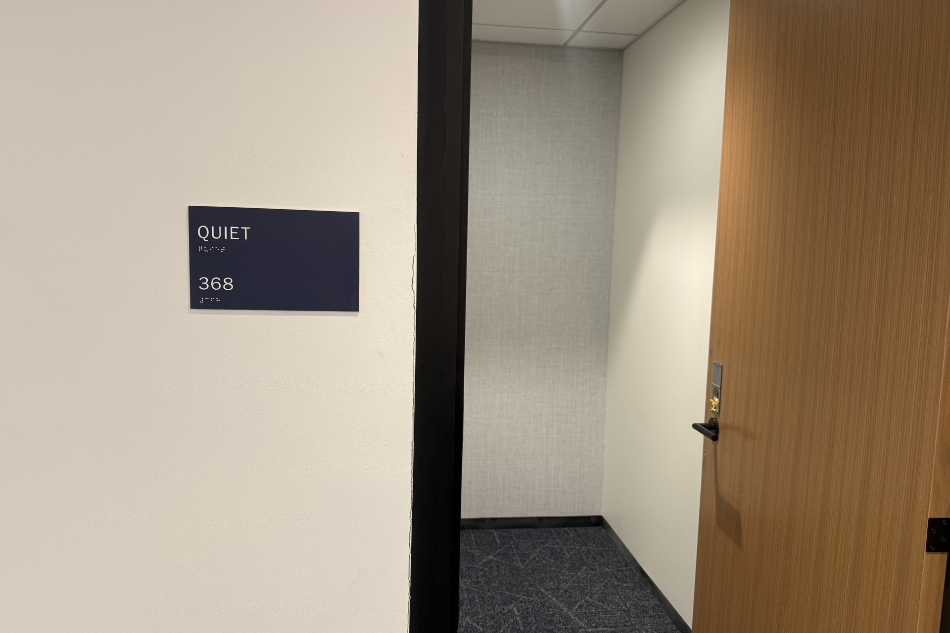 The exterior of a room that says Quiet Room on a sign